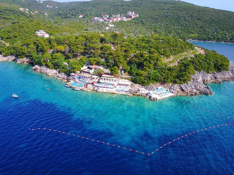 Zanjice Beach with clear turquoise water and sunbathers near Herceg Novi Zanjice Beach with clear turquoise water and sunbathers near Herceg Novi