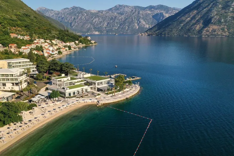 Our Lady of the Rocks island church with Perast behind it, Montenegro Our Lady of the Rocks island church with Perast behind it, Montenegro