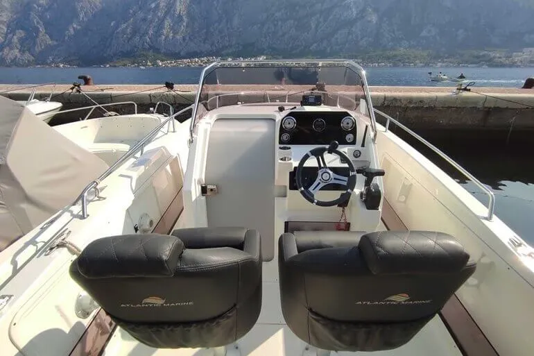Captain steering the 10-passenger speedboat through the bay Captain steering the 10-passenger speedboat through the bay