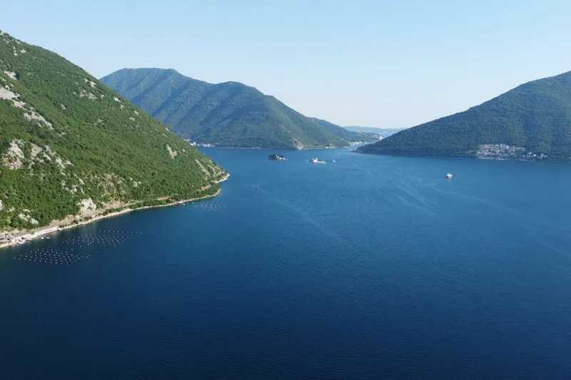 Fishing village houses along the Kotor Bay shore seen from the water Fishing village houses along the Kotor Bay shore seen from the water