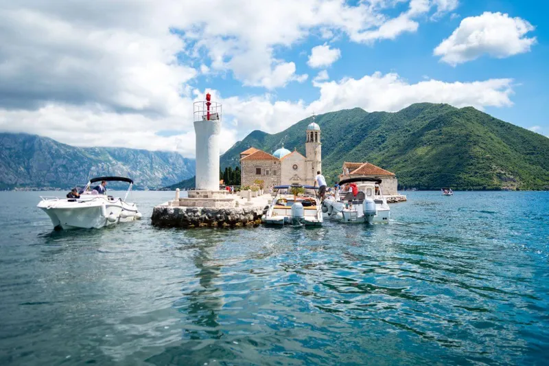 Panoramic view of Kotor fortress and Old Town from the water Panoramic view of Kotor fortress and Old Town from the water