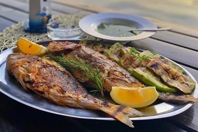 Family farm on the shore of Kotor Bay preparing fresh catch Family farm on the shore of Kotor Bay preparing fresh catch