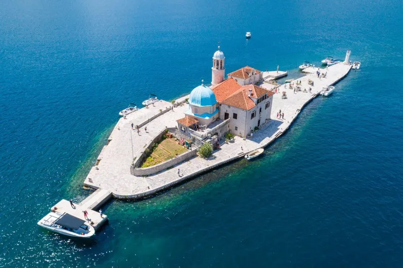 Our Lady of the Rocks island with its church dome in the Bay of Kotor Our Lady of the Rocks island with its church dome in the Bay of Kotor