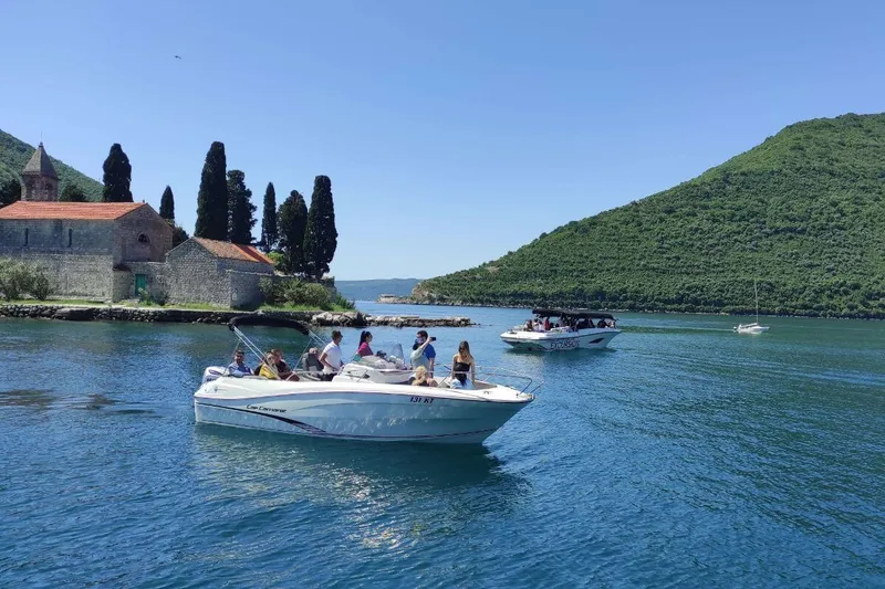 Guests arriving by speedboat at Our Lady of the Rocks island Guests arriving by speedboat at Our Lady of the Rocks island