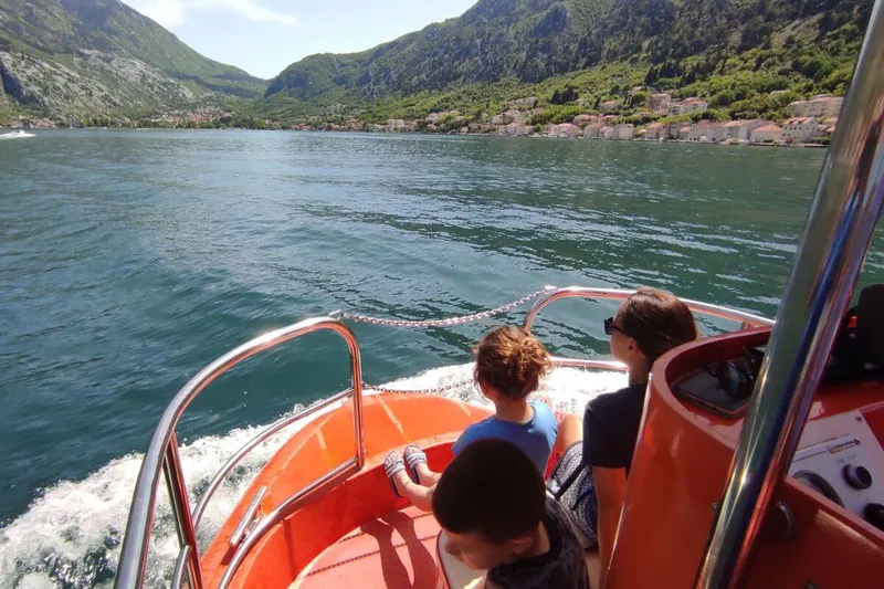 Red semi-submarine with guests on deck near Kotor Old Town, Montenegro Red semi-submarine with guests on deck near Kotor Old Town, Montenegro
