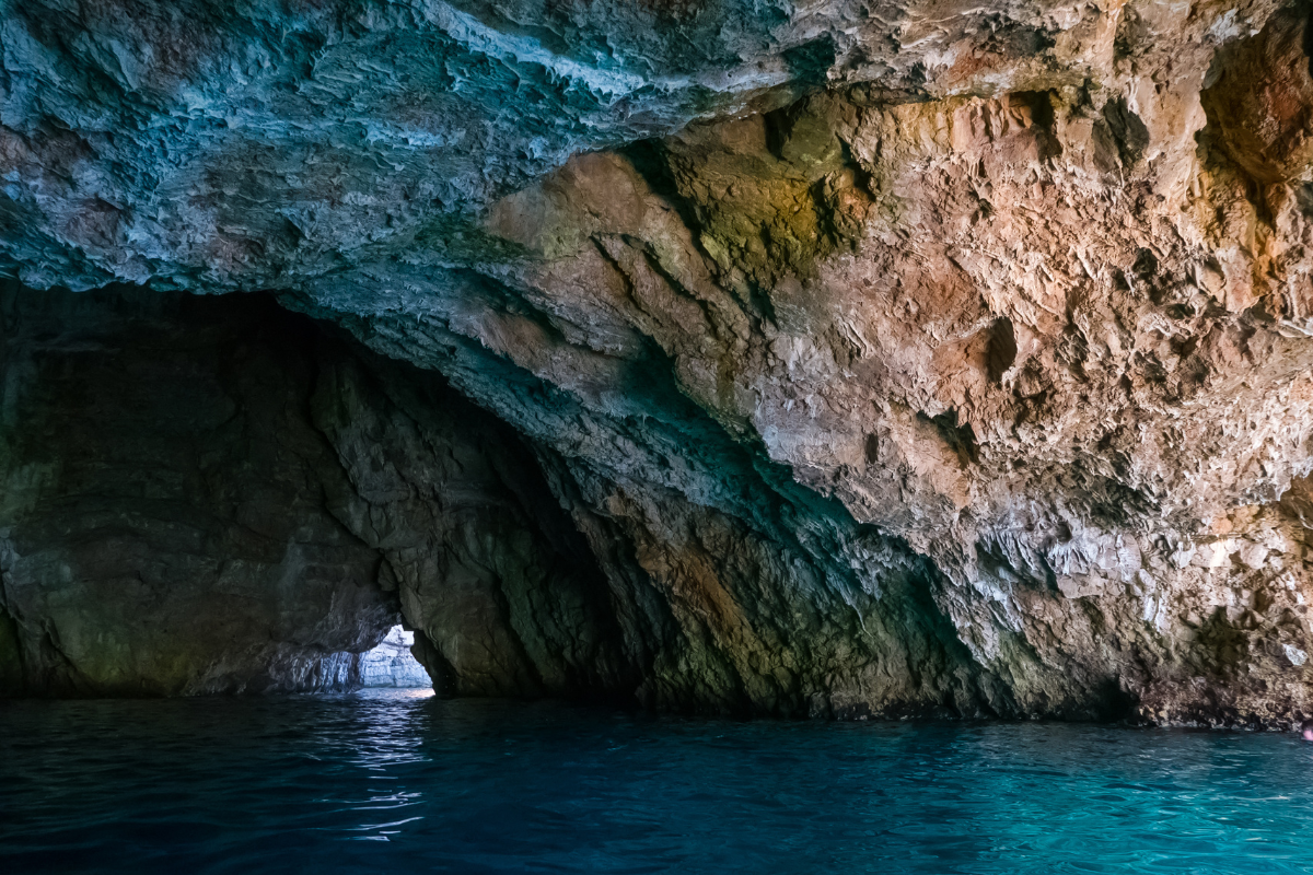 Guests swimming in the crystal-clear blue water inside the Blue Cave on a Montenegro Submarine tour