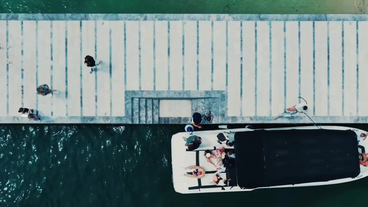 Drone view of one of our speedboats docked at the pier during the June 2026 MMA seminar boat day, guests boarding for the Bay of Kotor crossing
